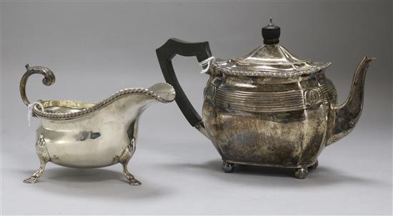 A small silver teapot and a silver cream boat